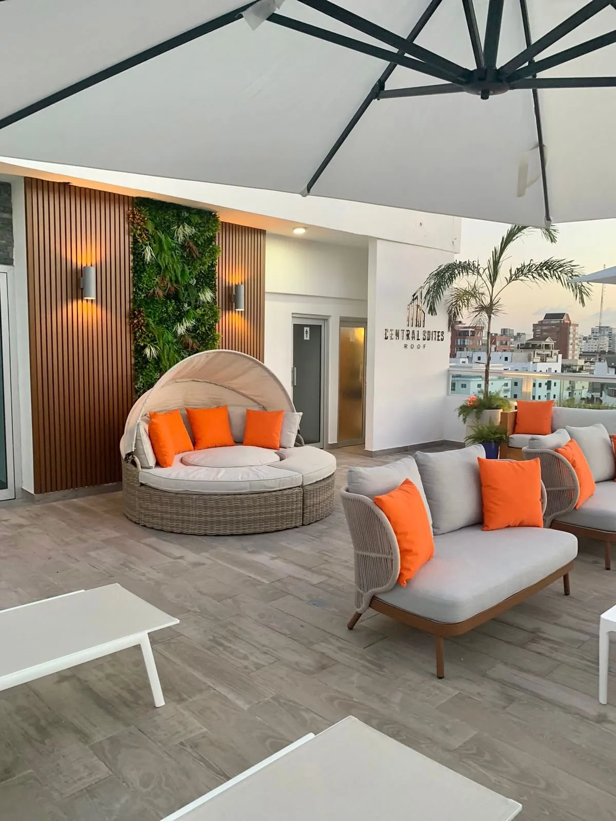 Rooftop terrace with sofas at Central Suites Tower at sunset